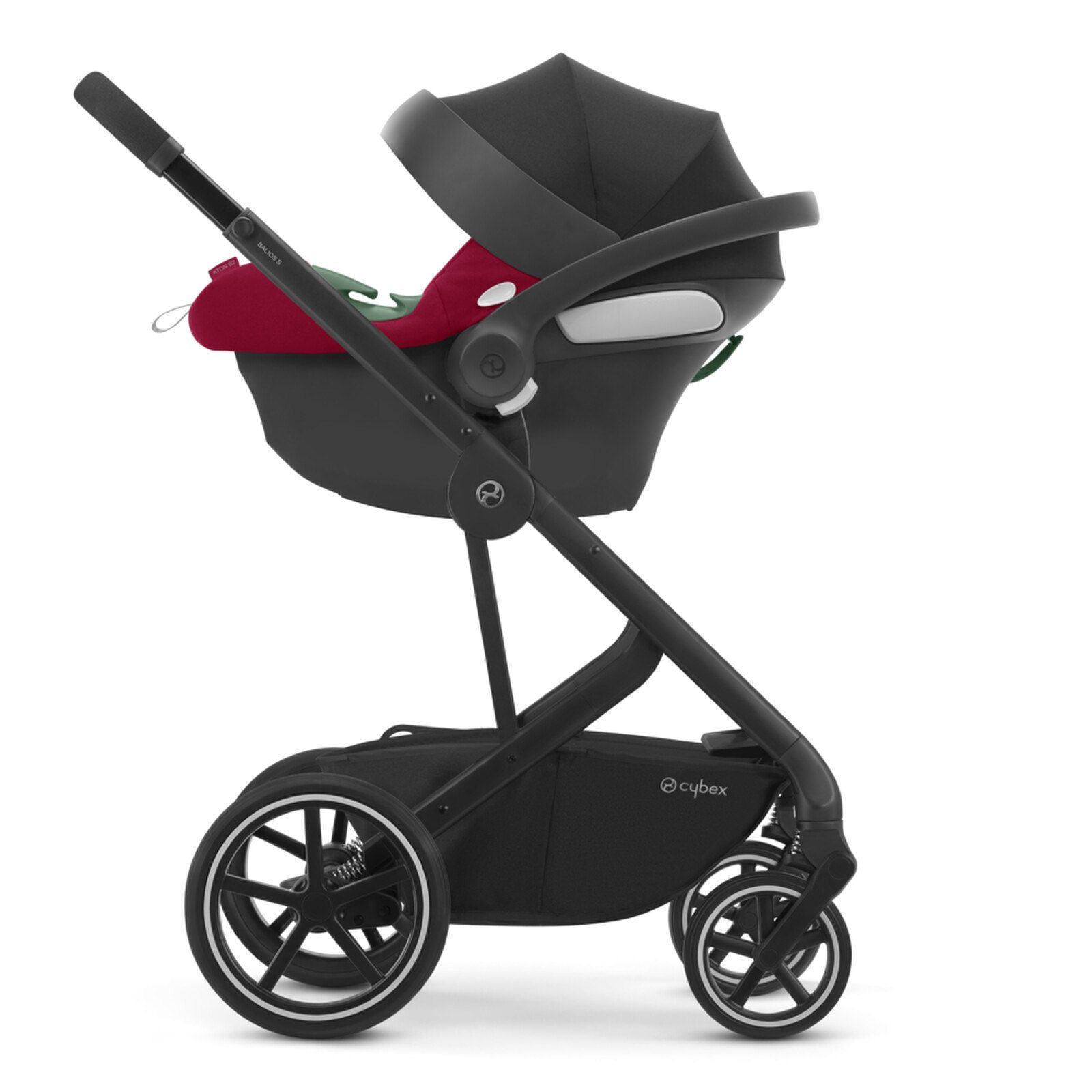 Coque Cybex Aton B2 i-Size posée sur un châssis de poussette, vue de profil.