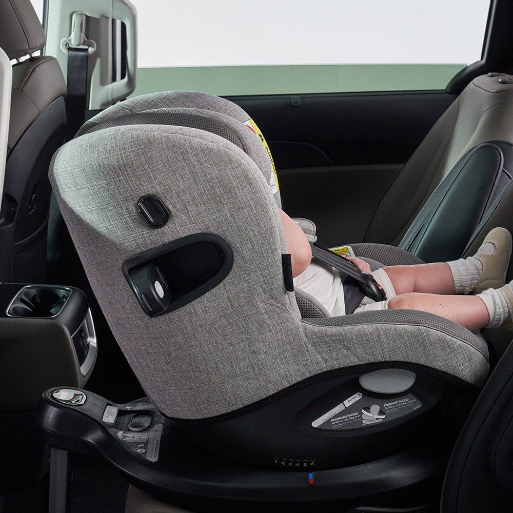 Le côté d'un i-Spin 360 gris chiné sur sa base, installé dans une voiture, avec la poignée de rotation visible.