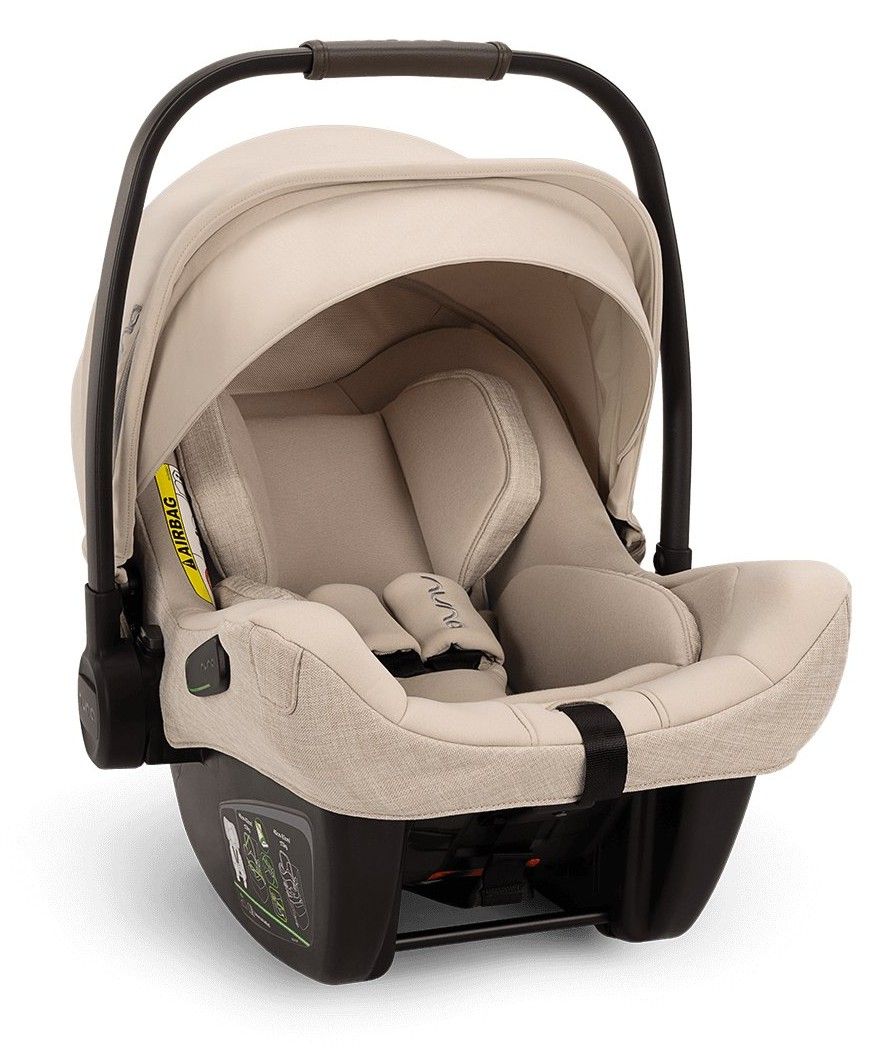 Coque bébé Nuna Pipa Next vue de trois quarts, capote relevée, sur fond blanc.